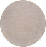Close-up of a round Brockton Solid Tan Area Rug. Hand-loomed wool rug with subtle striped texture. Design-Round-8
