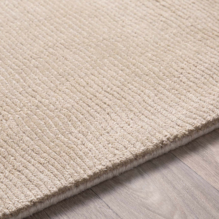 Close-up of the hand loomed Brockton Solid Tan Wool Area Rug showing its ribbed texture and neutral color. Texture