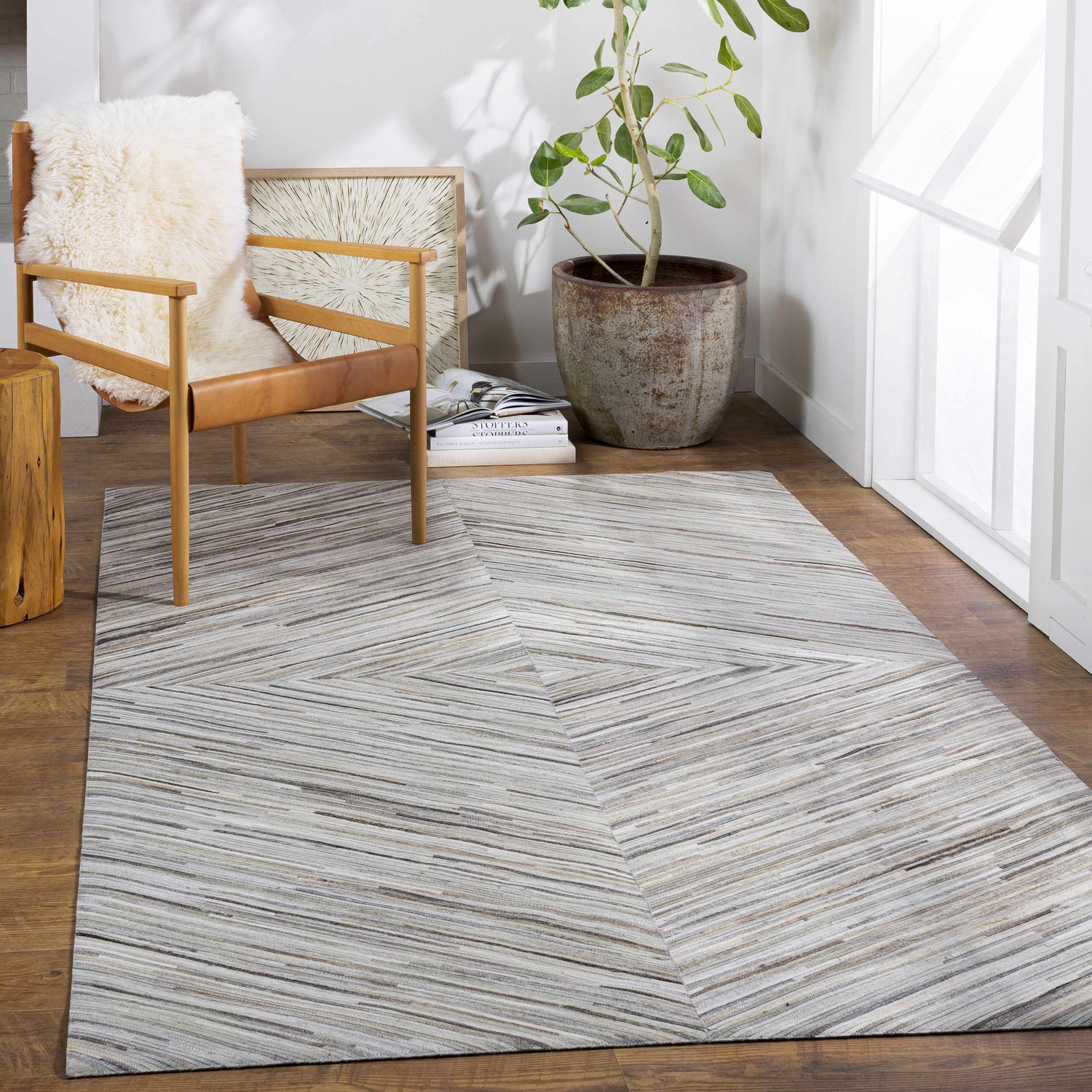 Modern room scene with Wauzeka Premium Area Rug, wood chair, plant, and natural light. Roomscene-Rectangle