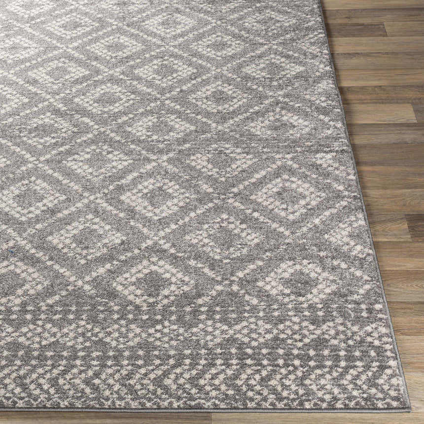 Close-up of the Webb Area Rug. Charcoal, gray, and white diamond pattern. Machine woven polypropylene rug. Front