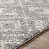 Close-up of the Webb Area Rug showing its gray and white abstract pattern and soft, textured pile. Texture