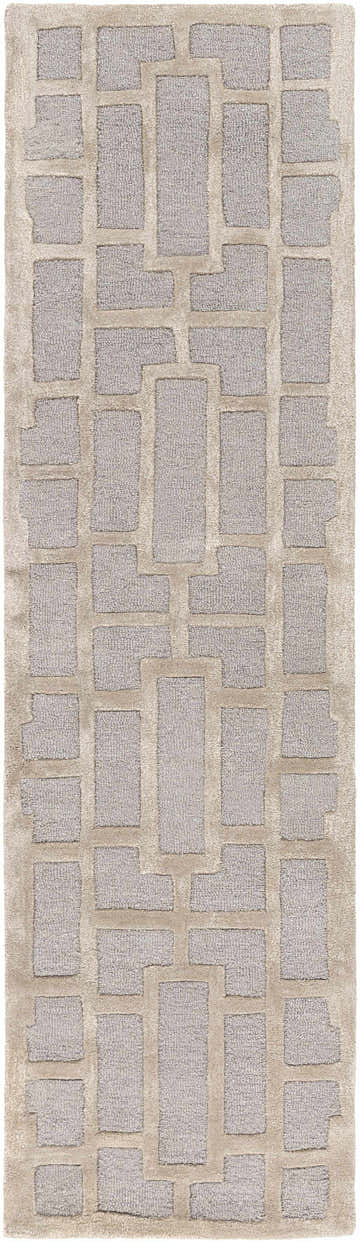 Close-up of the Wadesboro Area Rug. Beige wool rug with a light gray geometric pattern and hand-tufted texture. Design-Runner-38