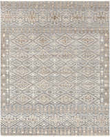 Close-up of the hand-knotted Woodsfield Premium Rug. Beige, brown, and gray geometric pattern. Wool rug texture. Design-Rectangle