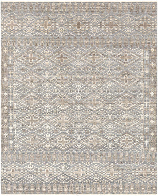 Close-up of the hand-knotted Woodsfield Premium Rug. Beige, brown, and gray geometric pattern. Wool rug texture. Design-Rectangle