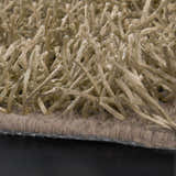 Close-up of the Browder Solid Beige Shag Area Rug showing its thick, soft, polyester pile and hand-woven construction. Texture