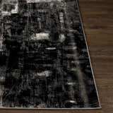 Close-up of the black, charcoal, and off-white Westpoint Area Carpet showing its contemporary pattern and texture. Front