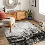 Living room scene with a black, charcoal, and off-white Westpoint Area Carpet, wood furniture, and modern decor. Roomscene-Rectangle
