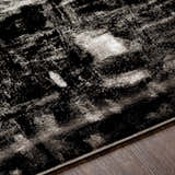Close-up of the Westpoint Area Carpet showing a black, charcoal, and off-white contemporary pattern and soft texture. Texture