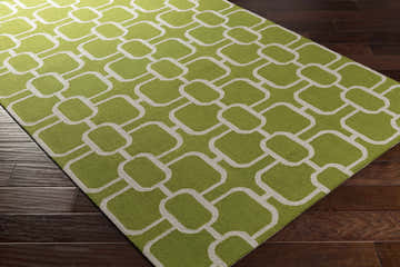 Close-up of the Wever Area Rug. Light gray geometric pattern on a lime green, hand-hooked wool rug. Corner