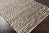 Close-up of Weymouth Jute Rug showing hand woven texture and striped pattern in cream, tan, teal, and black colors. Corner