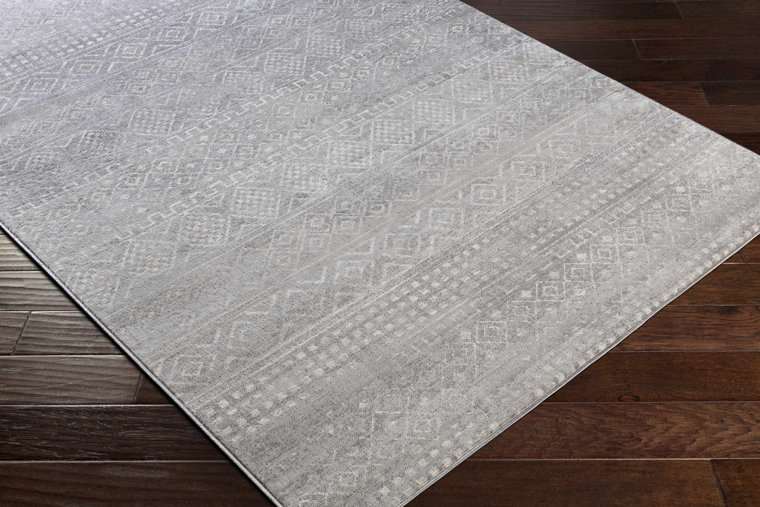 Close-up of the Whitesboro Gray Area Rug showing a subtle bohemian-inspired geometric pattern and soft texture. Corner