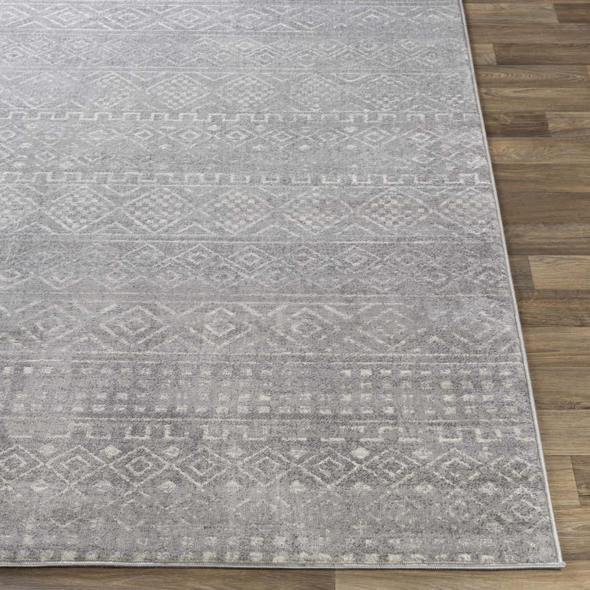 Close-up of the Whitesboro Gray Area Rug, showing a geometric, bohemian pattern in charcoal, gray, and white tones. Front