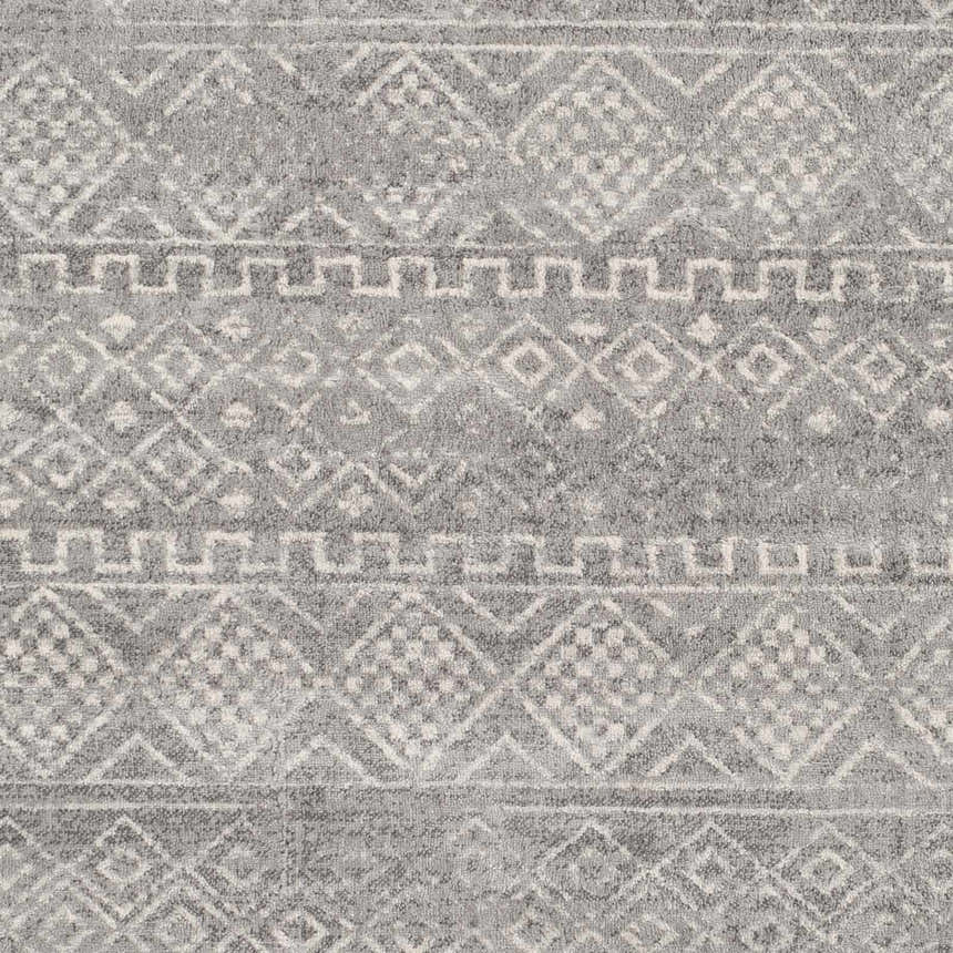 Close-up of the Whitesboro Gray Area Rug featuring a geometric, Bohemian-inspired pattern in charcoal, gray, and white. Swatch