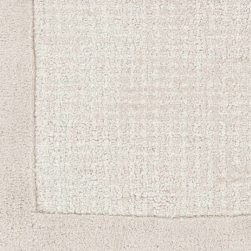 Close-up of the hand-tufted Winooski Area Rug. Cream and light gray wool rug with a solid striped design and soft texture. Swatch