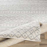 Close-up of the Winston Area Rug in cream and gray, showcasing its geometric pattern and machine-woven texture. Fold