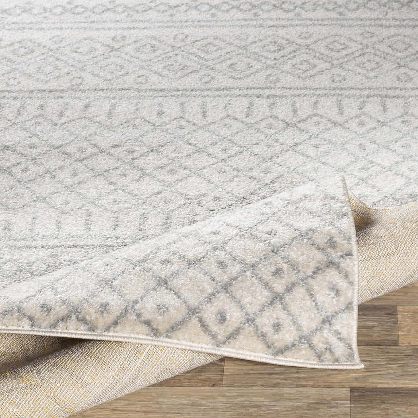 Close-up of the Winston Area Rug in cream and gray, showcasing its geometric pattern and machine-woven texture. Fold