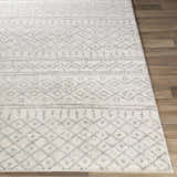 Close-up of the Winston Area Rug showing its cream and gray Bohemian-inspired geometric pattern and soft texture. Front