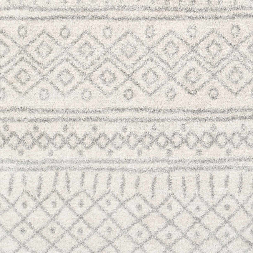 Close-up of the Winston Area Rug showing a cream base with medium gray geometric, bohemian-inspired patterns. Swatch