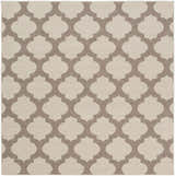 Close-up of the Winterville Area Rug showing a beige and dark red quatrefoil pattern. Design-Square-73