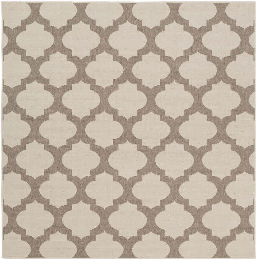 Close-up of the Winterville Area Rug showing a beige and dark red quatrefoil pattern. Design-Square-73