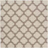 Close-up of the Winterville Area Rug showing a beige and dark red quatrefoil pattern. Design-Square-73