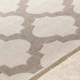 Close-up of the Winterville Area Rug showing beige and dark red quatrefoil pattern and olefin texture. Texture