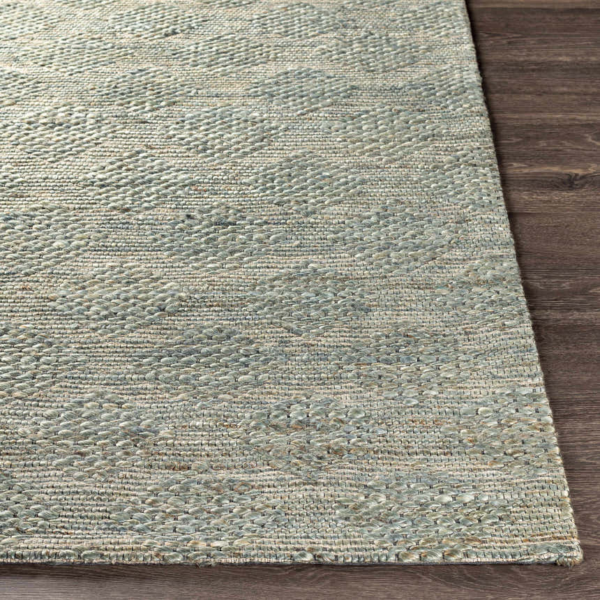 Close-up of the hand woven Wishaw Sage Green Jute Rug showing its texture and subtle diamond pattern. Front