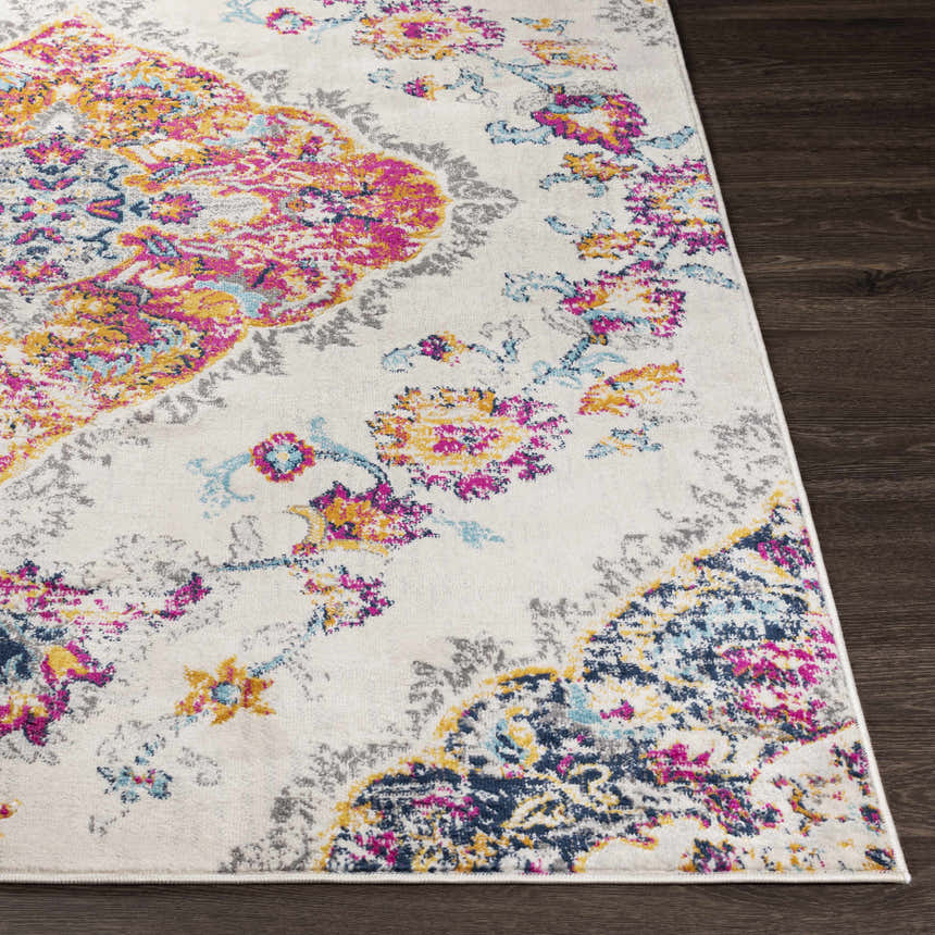 Close-up of the Wallsburg Magenta & Cream Area Rug. Features a bohemian floral pattern with cream, magenta, yellow, and blue accents. Front