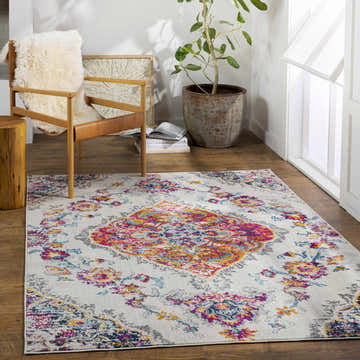 Bright living room with Wallsburg Magenta & Cream Area Rug, wood chair, and plant. Bohemian style. Roomscene-Rectangle