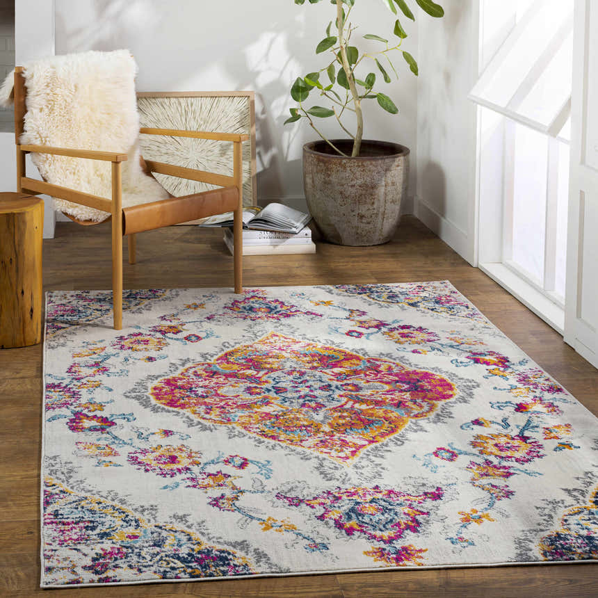Bright living room with Wallsburg Magenta & Cream Area Rug, wood chair, and plant. Bohemian style. Roomscene-Rectangle