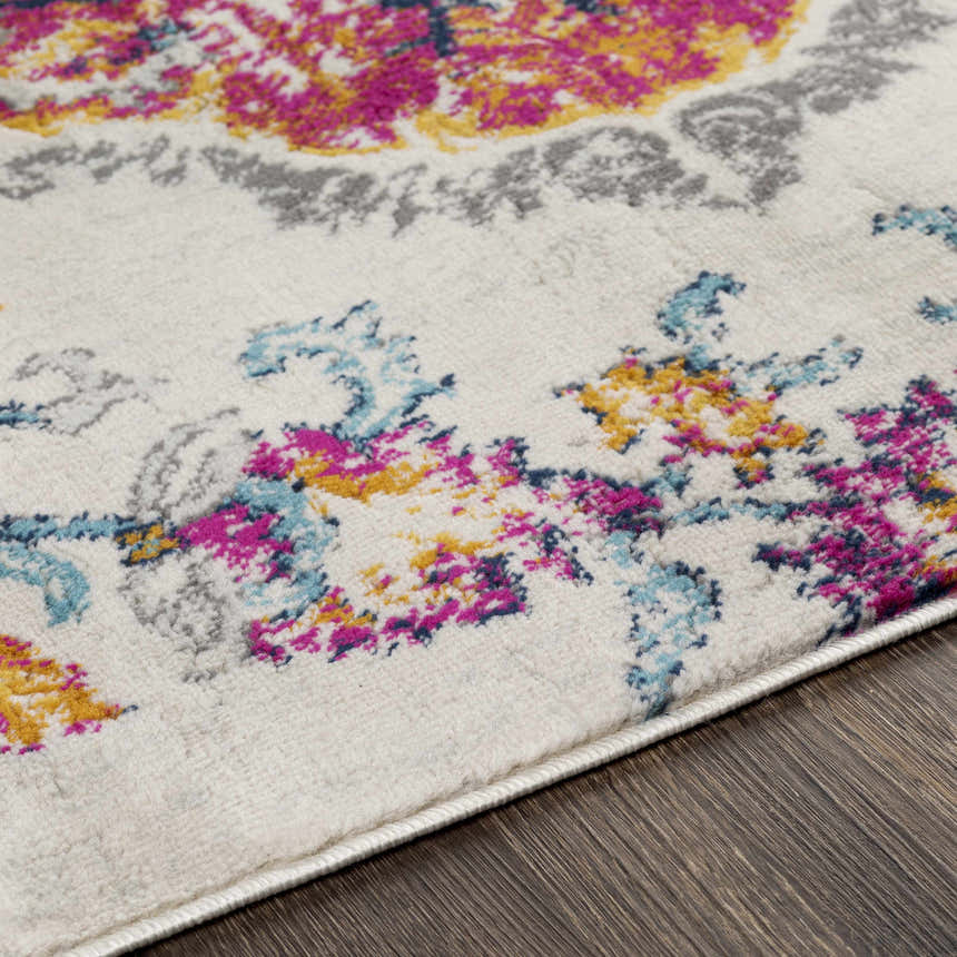 Close-up of the Wallsburg Magenta & Cream Area Rug showing its floral pattern with magenta, cream, yellow, and blue colors. Texture