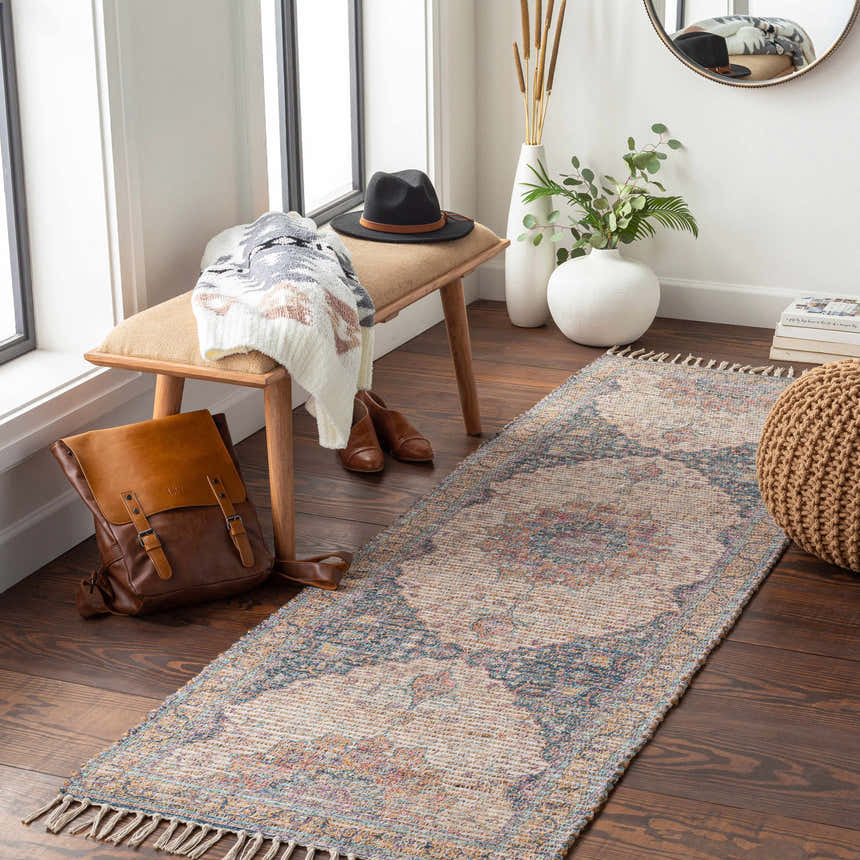 Entryway with Wallburg Hand Woven Colorful Tassel Rug, wood bench, brown leather backpack, and round mirror. Roomscene-Runner