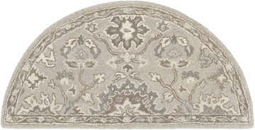 Close-up of the Hearth-shaped Willimantic Beige Thick Wool Rug with a traditional floral pattern in taupe, tan, and light beige. Design-Hearth