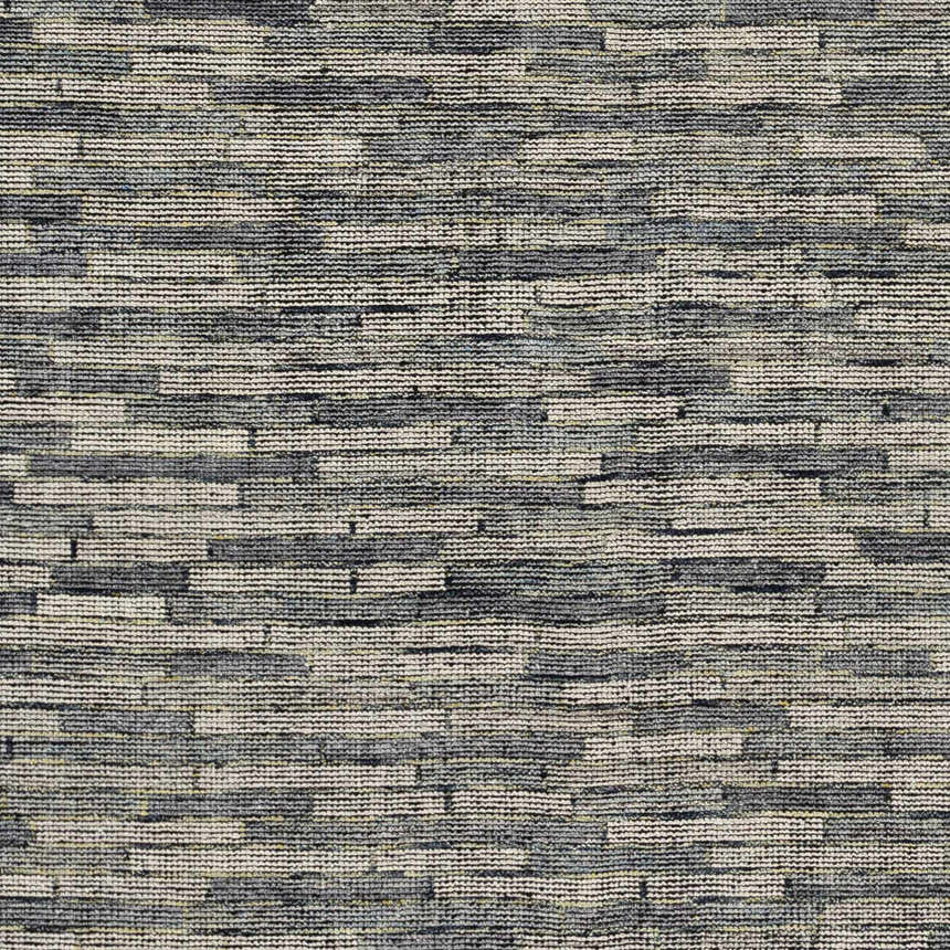 Close-up of the hand-knotted Willmar Premium Rug. Denim, ink blue, light olive, and sage colors create a contemporary design. Texture