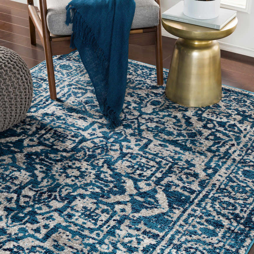 Living room scene with blue and gray Wellsblue Traditional Rug, chair, and gold accent table. Roomscene-Rectangle