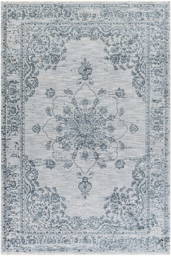 Close-up of the Wandina Traditional Luxe Rug. Cream and dark blue floral pattern on a gray, machine-woven polyester rug. Design-Rectangle-6796
