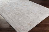 Close-up of the Windale Textured Luxe Area Rug in off-white and brown on dark hardwood flooring. Contemporary style. Corner