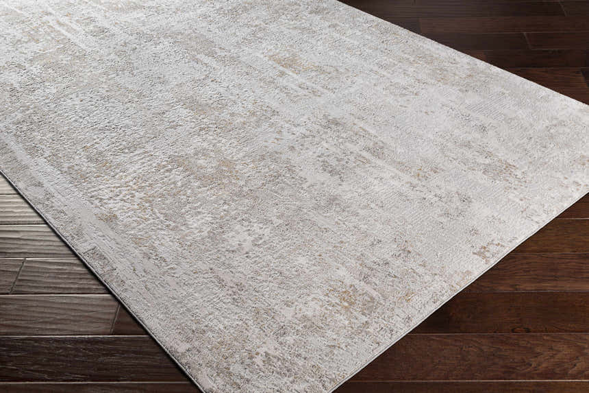 Close-up of the Windale Textured Luxe Area Rug in off-white and brown on dark hardwood flooring. Contemporary style. Corner