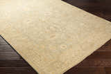 Close-up of the hand-knotted Wooroloo Area Rug. Beige, olive, and yellow tones with a traditional oriental pattern. Corner