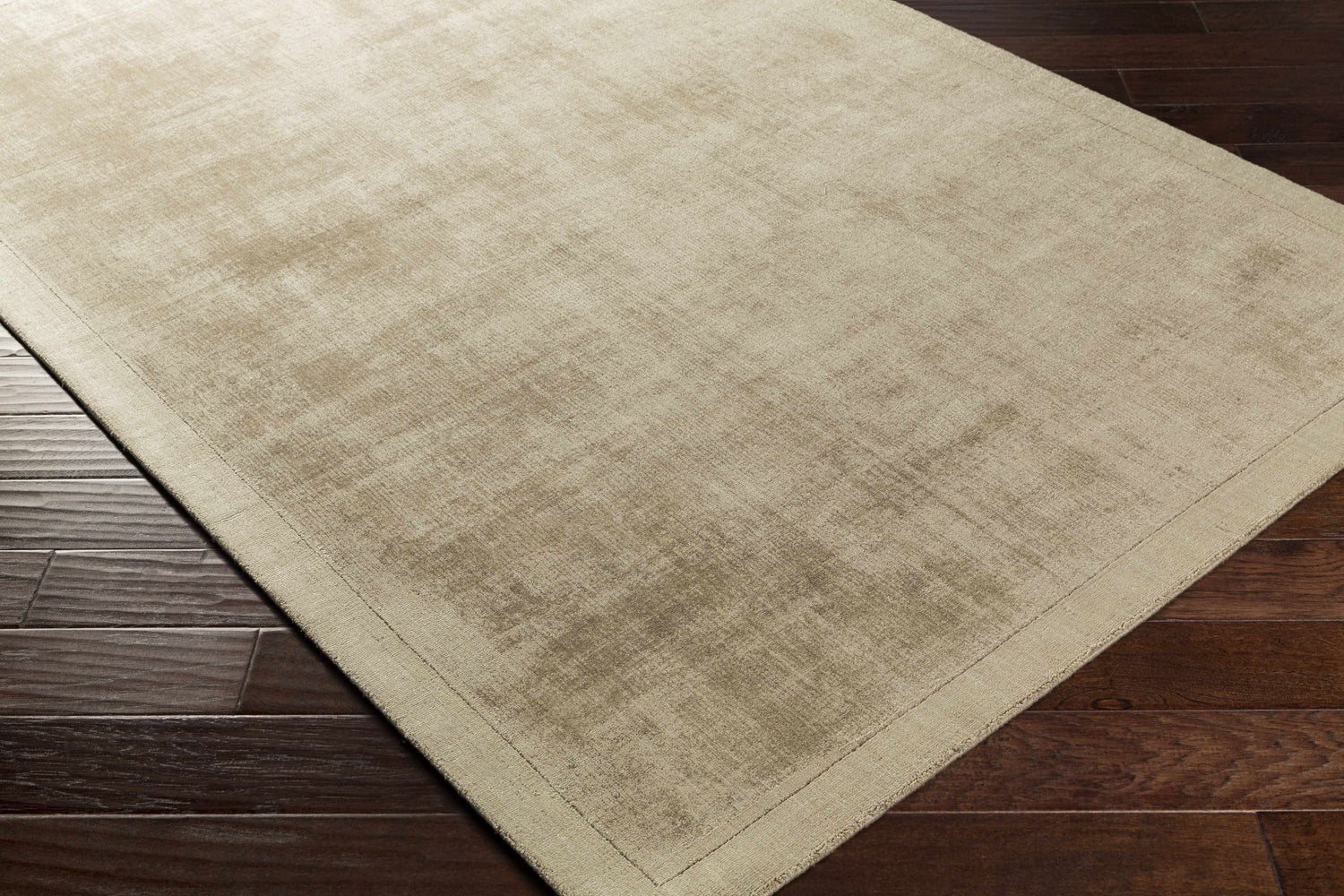 Close-up of the taupe Westbend Area Rug showing its subtle striped design and soft viscose texture on dark wood flooring. Corner