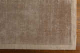 Close-up of the taupe Westbend Area Rug showing its subtle striped pattern and hand-loomed texture on a wood floor. Corner