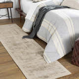 Bedroom scene with taupe Westbend area rug, striped bedding, wood floors, and a cozy, neutral aesthetic. Roomscene-Runner