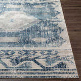 Close-up of the Westmount Denim Aztec Area Rug. Features a cream and denim blue geometric design on a textured rug. Front