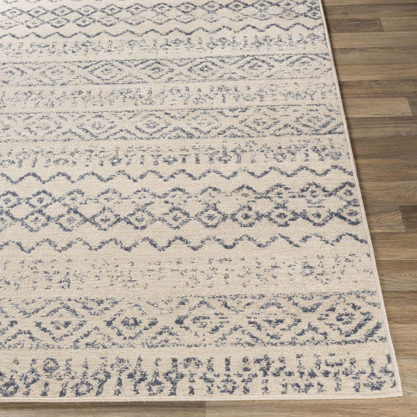 Close-up of the Westborough Beige Area Rug showing its contemporary blue and cream geometric pattern and soft texture. Front