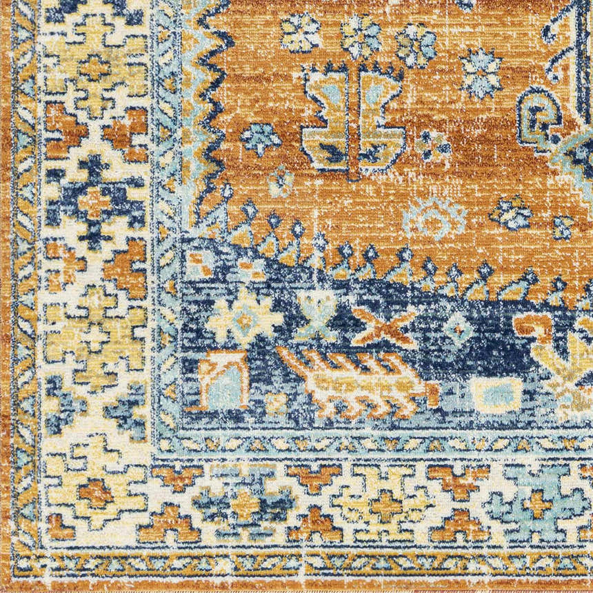 Close-up of Trotters Orange/Blue Performance Rug. Features a traditional, bohemian pattern with brick red, navy, and ivory hues. Swatch