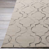 Close-up of the hand woven Wycombe Area Carpet. Black and light gray Moroccan trellis pattern on a taupe wool rug. Front