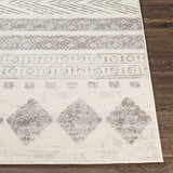 Close-up of the Wyoming Area Rug showing its gray bohemian pattern and soft texture on a dark wood floor. Front