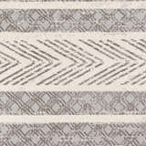 Close-up of the Wyoming Area Rug showing a geometric pattern in charcoal, gray, and off-white hues. Swatch