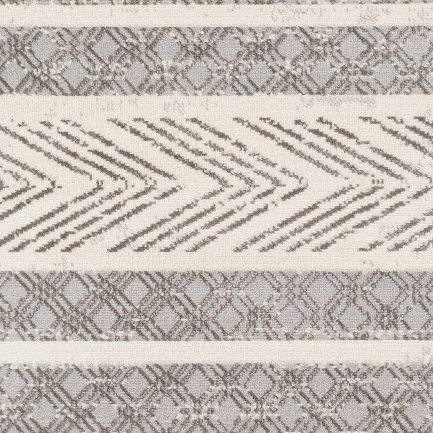 Close-up of the Wyoming Area Rug showing a geometric pattern in charcoal, gray, and off-white hues. Swatch