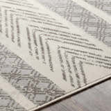 Close-up of the Wyoming Area Rug showing its gray, off-white, and charcoal bohemian-inspired geometric pattern. Texture